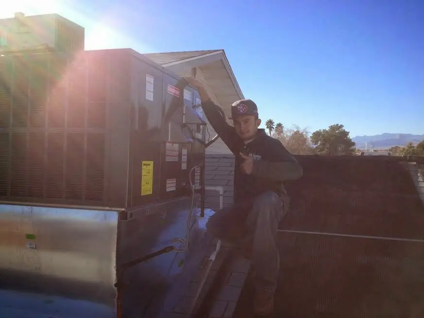 HVAC technician performing HVAC Inspection on a rooftop unit in Ottawa